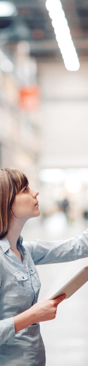 Request a quote from production supply store featuring woman picking from our inventory in warehouse